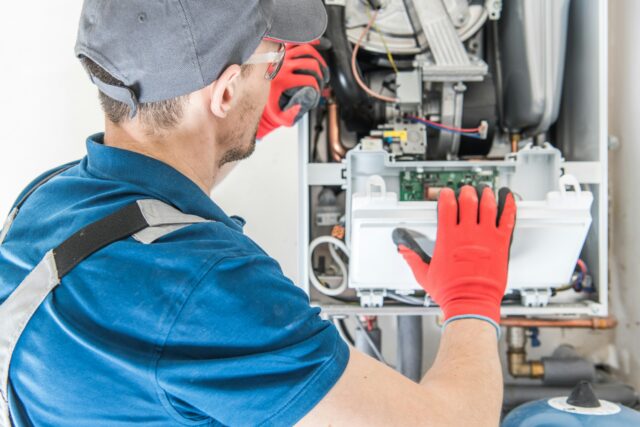 Technician carrying out an annual service for a residential boiler